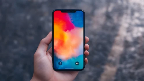 Mobile device displaying gradient color field composition.