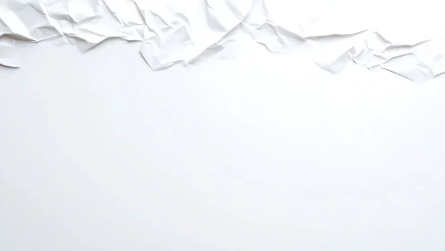 Crumpled white paper edge on plain minimal background.