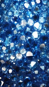 Macro cluster of faceted blue gemstones under specular lighting