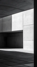 Minimalist concrete corridor in stark light and shadow.