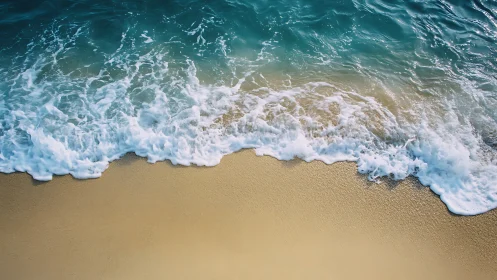 Gentle turquoise waves roll onto a tranquil sandy shore