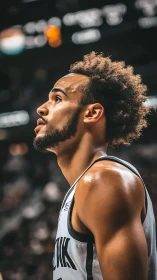 Courtside comet in grayscale jersey, locked on the rim.