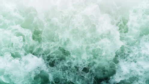 Gentle sea foam swirling in soft mint green waves.