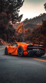 Orange hypercar on winding mountain road at sunset.
