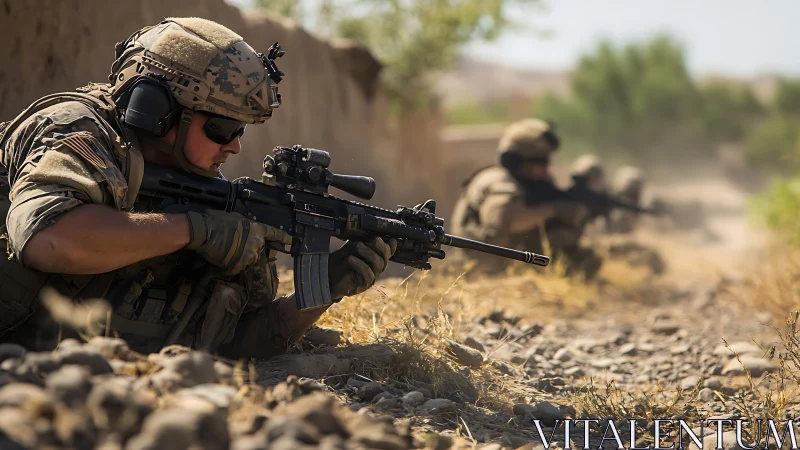 Soldier in prone firing position with optics-equipped rifle in arid terrain
