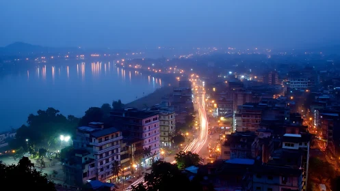 City avenue and lakeside lights captured at blue hour.