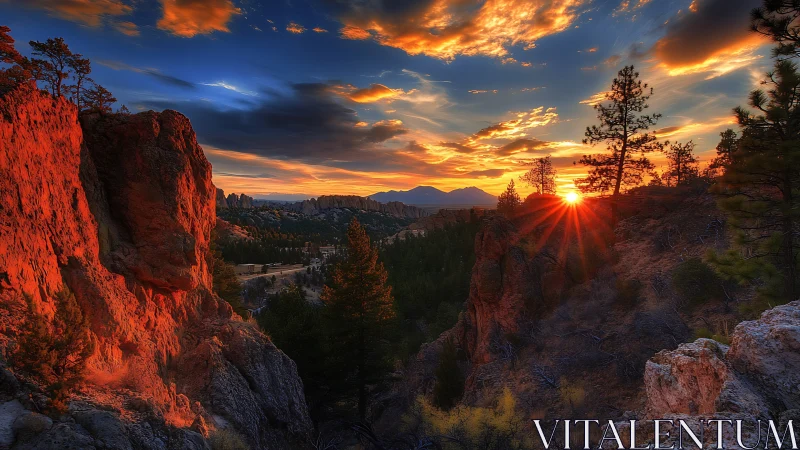Sunset over rocky canyon cliffs and distant forested valley.