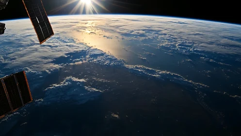 Sunrise spills golden light across Earth’s blue horizon