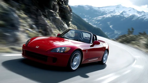 Red convertible sports car on curved alpine mountain road.