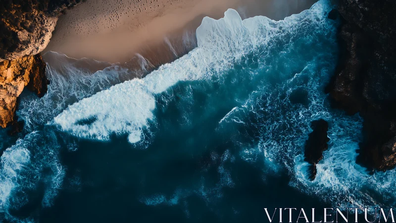 Overhead coastal surf against rocky cliffs and sand shore.