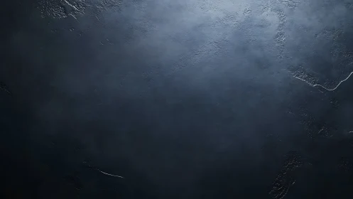 Dark textured surface with subtle cracks and rough areas.