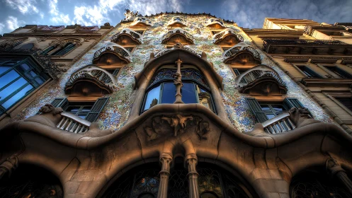 Ornate multistory façade with sculpted balconies and mosaics
