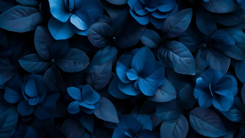 Monochrome blue floral foliage pattern in close-up view.