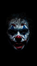 Sinister clown portrait emerges from deep black background