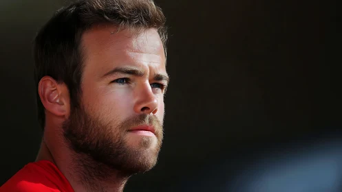 Thoughtful bearded man gazes into soft dramatic light.