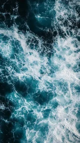 Turbulent teal ocean surface shows high-contrast foam patterns