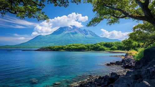 Majestic Volcano Crowned in Clouds Above Turquoise Waters.