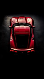 Red sports coupe glows under narrow overhead studio light
