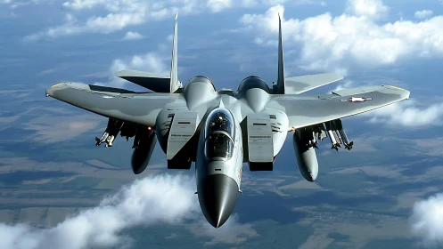 Sleek fighter jet soars confidently above soft rolling clouds