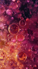 Glowing pink oil bubbles drift in warm abstract cosmic haze
