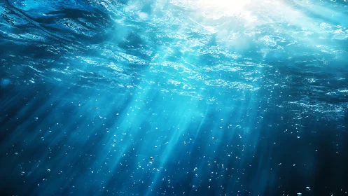 Underwater sunbeams illuminating clear blue ocean depth.