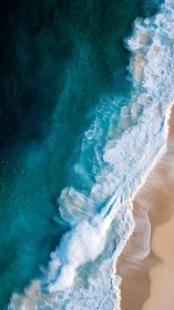 Tumbling teal breakers sketch bright ribbons across sand