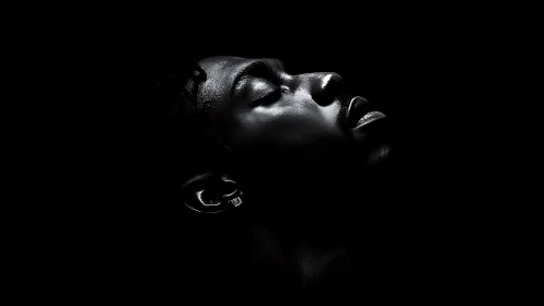 Side profile portrait in deep black negative space.