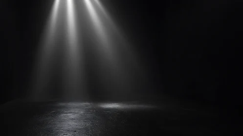 Twin spotlights slice through darkness onto empty floor.
