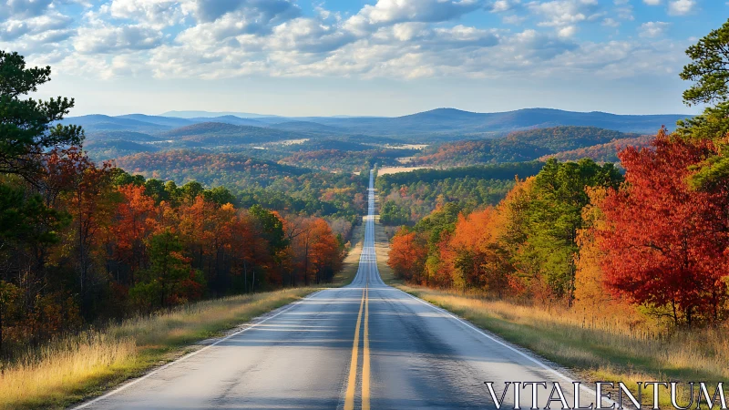 Endless autumn highway carving through rolling painted hills.
