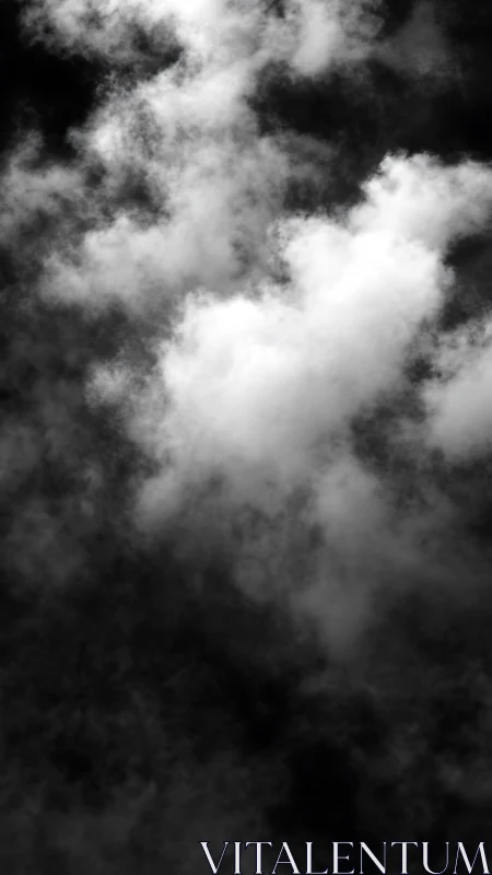 Monochrome vertical cloud formation against dark sky.