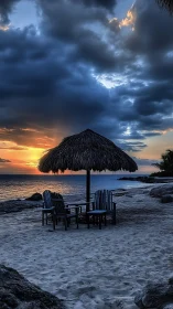 Dramatic sunset beach scene with palapa canopy and chairs