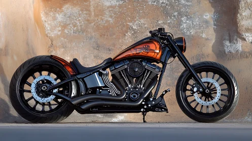 Custom low-slung motorcycle is parked against textured wall