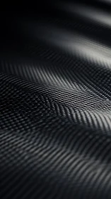 Dark woven surface pattern with directional light highlights.