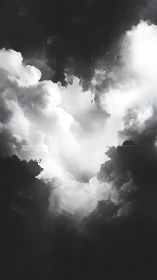 Monochrome cloud mass against deep contrasting darkness.
