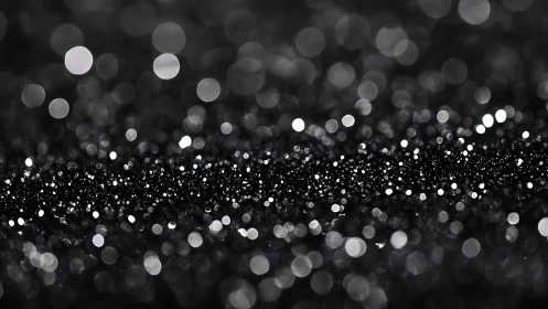 Glittering black bokeh lights shimmer in soft abstract focus