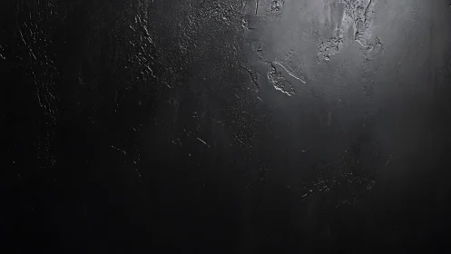 Dark textured concrete wall background with subtle light falloff.