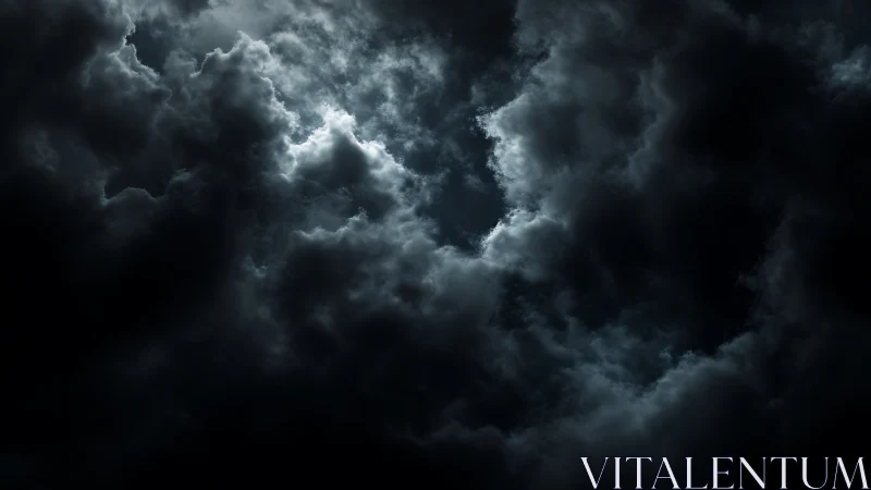 Moody storm clouds curl gently around a soft silver glow