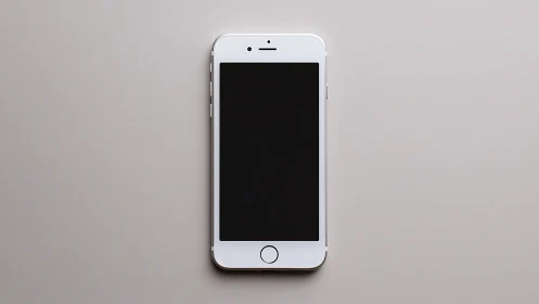 White Smartphone Against Gray Background.