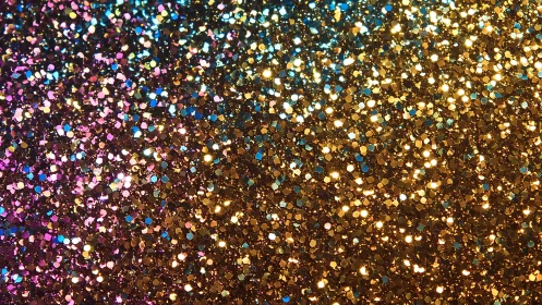 Multicolored metallic glitter fills the frame in tight focus