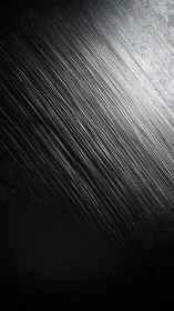 Dark diagonal scratched metal texture in sharp light.