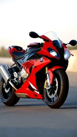 Red BMW sport motorcycle stands on open asphalt road