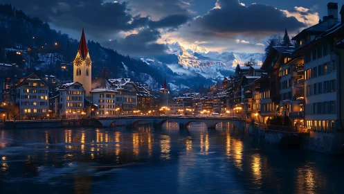 Snowy alpine town riverfront at blue hour with lit bridge.
