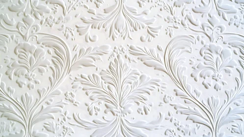 Ornate white floral relief decorates an elegant wall surface.
