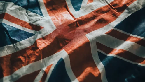 Bold Union Jack flag rests in soft, warmly lit folds