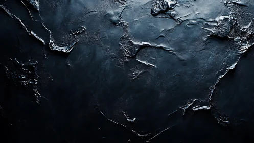 Dark textured abstract surface with dramatic lighting effects.