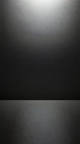 Softly lit dark studio backdrop with calm reflective floor.