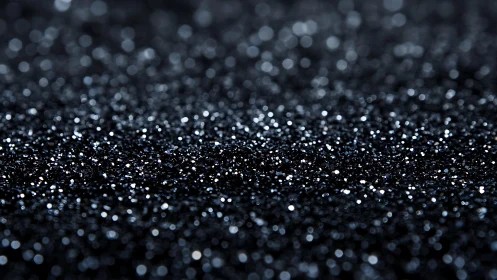 Sparkling black glitter surface in abstract macro photography style.