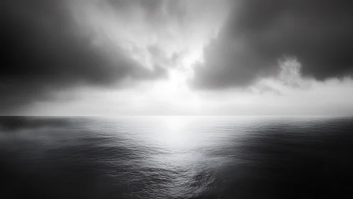 Monochrome ocean horizon under dense storm cloud bank.