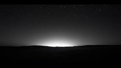 Astrophotographic horizon glow under high-contrast night sky.