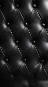 Black tufted leather upholstery with glossy diamond pattern.